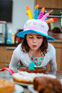 Portrait of cute girl with ice cream on table
