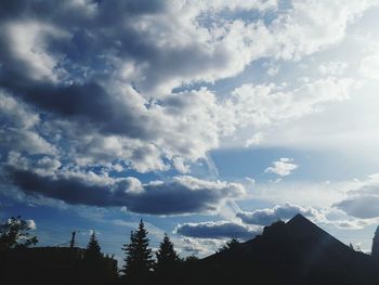 Low angle view of building against cloudy sky