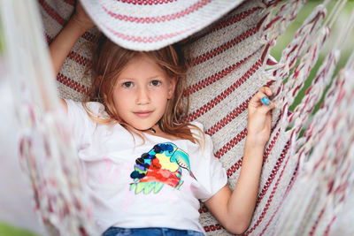 Portrait of cute girl playing in hammock