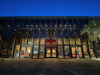 Illuminated building against clear sky at night