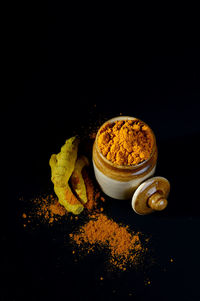 Close-up of food on table against black background