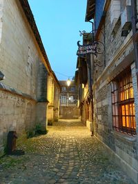 Street amidst buildings against sky in city