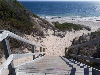 High angle view of staircase by sea against sky