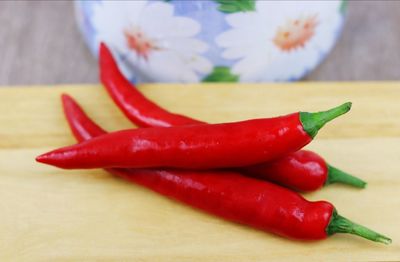 Close-up of red chili peppers on table