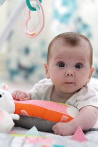 Surprised cute curious baby staring at the camera . big eyes amazed baby face expression