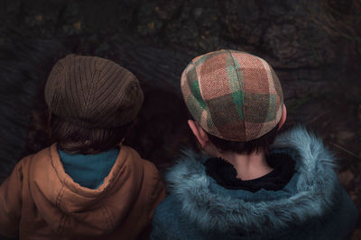 Close-up of two boys dressed in warm autumn. back view.	