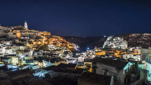 High angle view of illuminated buildings in city at night