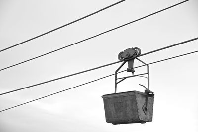 Low angle view of electric lamp against sky