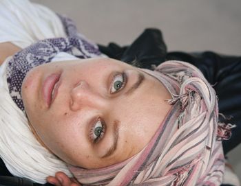 Close-up portrait of woman wearing headscarf at home