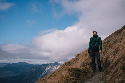 Man standing on mountain against sky