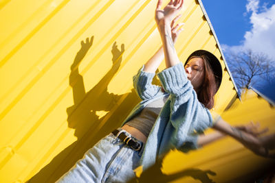 Low angle view of woman sitting outdoors