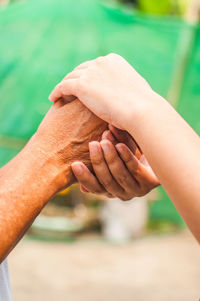 Cropped image of people holding hands