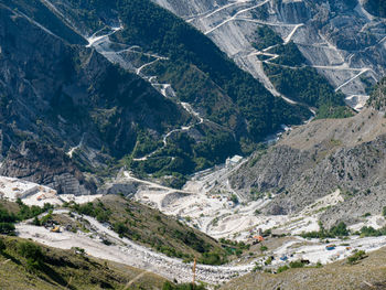 View of the carrara marble quarries and the transport trails carved into the side of the mountain.