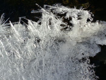 Close-up of water splashing in winter against sky