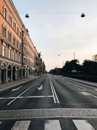 Empty road along buildings
