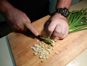 Close-up of man preparing food on cutting board