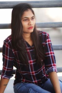 Beautiful young woman sitting at home