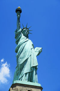 Low angle view of statue against blue sky