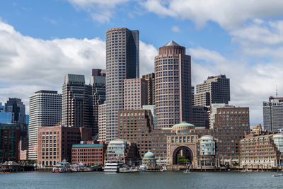 View of skyscrapers against cloudy sky