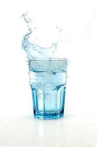 Close-up of water splashing against white background