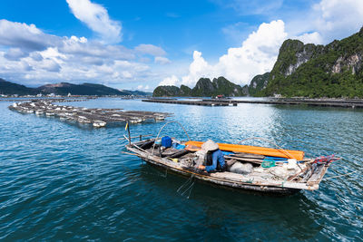 Woman fishing in sea against sky