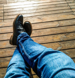 Low section of man sitting on wooden floor