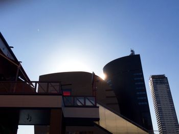 Low angle view of buildings against clear blue sky