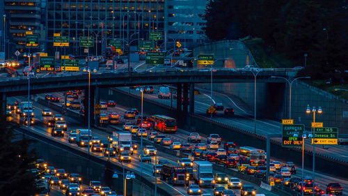 High angle view of illuminated buildings in city at night,traffic jam