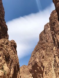 Low angle view of rocky mountains against sky