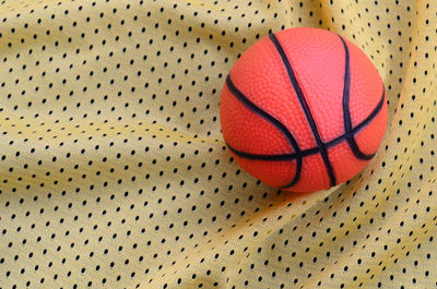 Directly above shot of basketball on patterned fabric