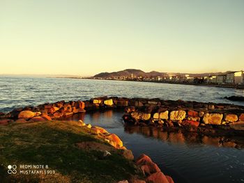 Scenic view of sea against clear sky during sunset