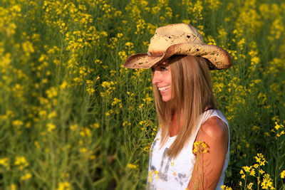 Portrait of smiling woman with yellow flowers