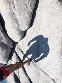 Low section of man shadow on hand