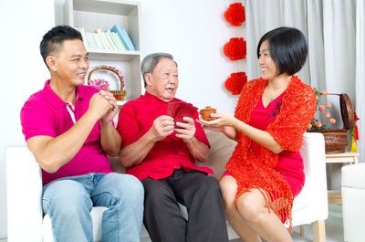 Happy family sitting on sofa at home