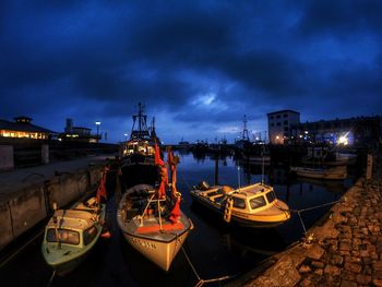 View of boats moored at night
