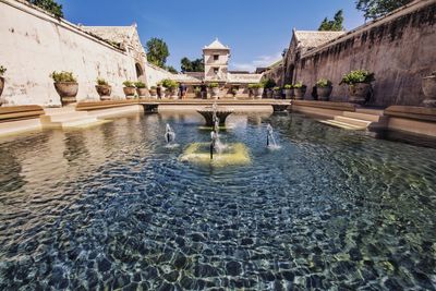 View of fountain in city against sky