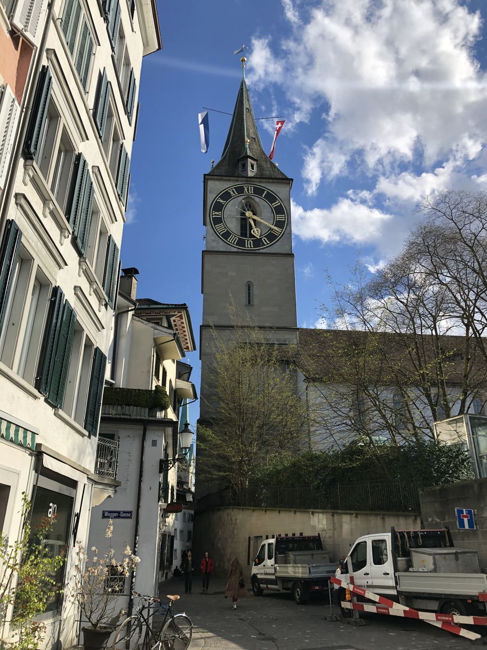 LOW ANGLE VIEW OF CLOCK TOWER AND BUILDINGS AGAINST SKY