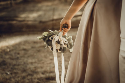 Bride with flower bouquet. summertime sunset