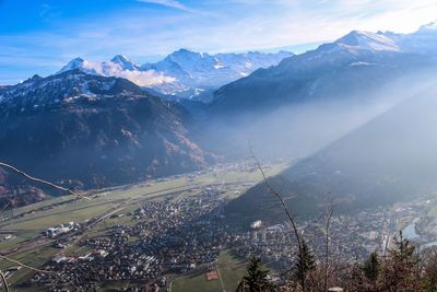 Aerial view of townscape against mountain range