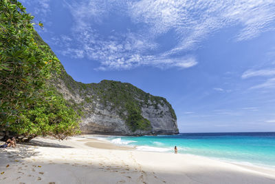 Scenic view of beach against blue sky