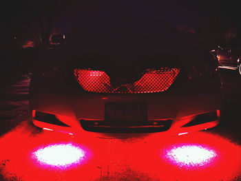 Close-up of illuminated red lights at night