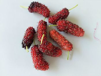 High angle view of chopped strawberries on white background