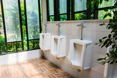 Close-up of urinals at public restroom