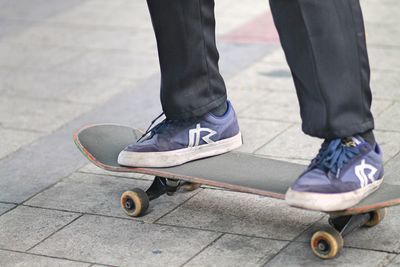 Young boy on a skateboard   on pavement 