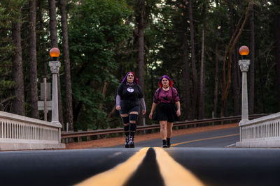 Gothic women walking on paved road