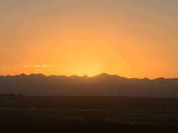 Scenic view of silhouette mountains against sky during sunset