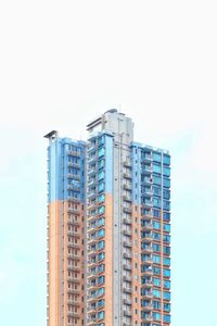 Low angle view of modern building against blue sky