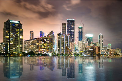 View of skyscrapers lit up at night