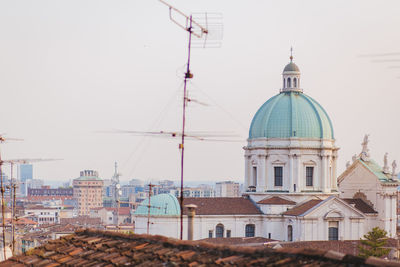 View of buildings in city against clear sky