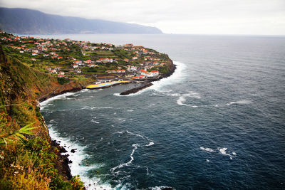 High angle view of buildings on mountain by sea